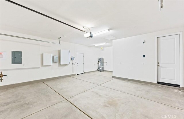 garage featuring baseboards, electric panel, and a garage door opener