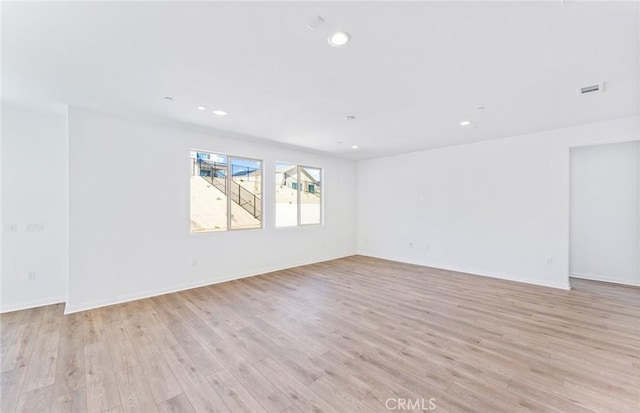 unfurnished room with baseboards, recessed lighting, visible vents, and light wood-style floors