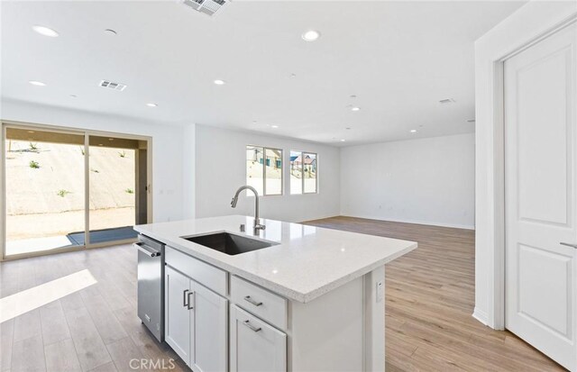 kitchen with light wood-style floors, visible vents, and a sink