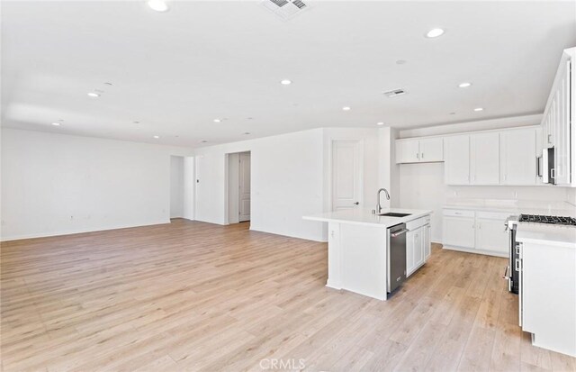 kitchen with visible vents, appliances with stainless steel finishes, open floor plan, and a sink