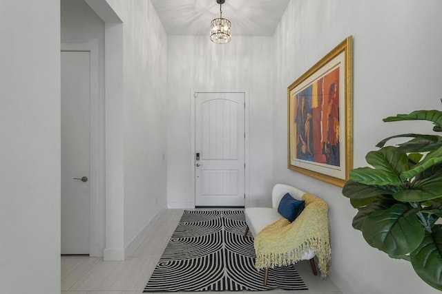 interior space featuring light tile patterned floors and a chandelier