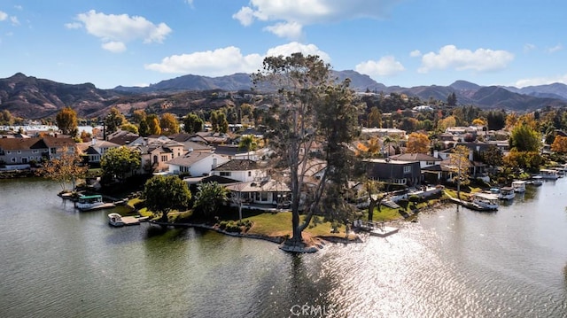 aerial view featuring a water and mountain view