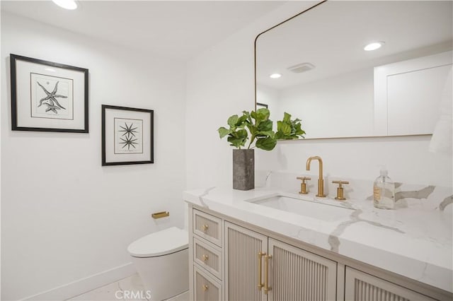 bathroom featuring toilet, vanity, and tile patterned floors