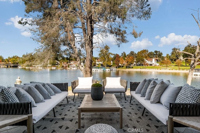 view of dock featuring an outdoor living space and a water view