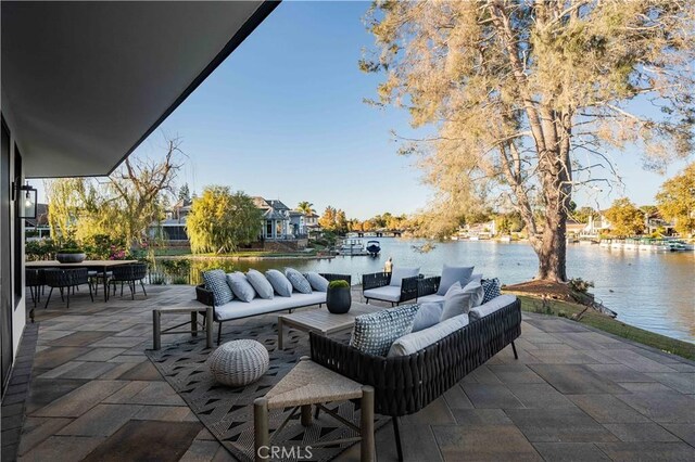 view of patio / terrace featuring outdoor lounge area and a water view