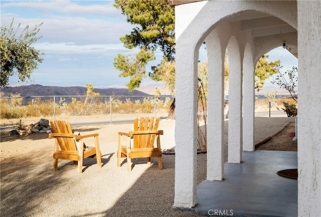 view of patio / terrace featuring a mountain view and fence