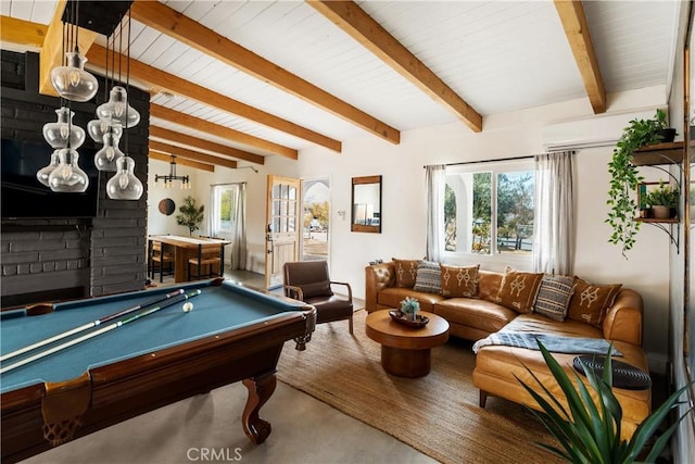 recreation room with beam ceiling, plenty of natural light, and a fireplace