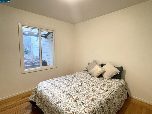 bedroom with wood-type flooring