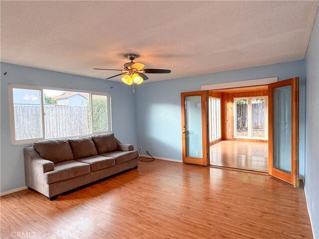 living room with light hardwood / wood-style floors and a textured ceiling