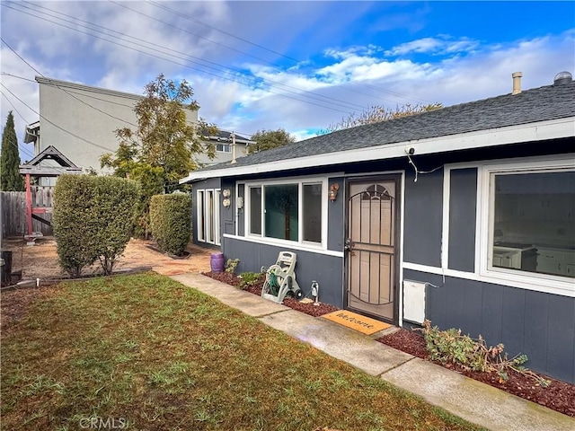 doorway to property with a yard