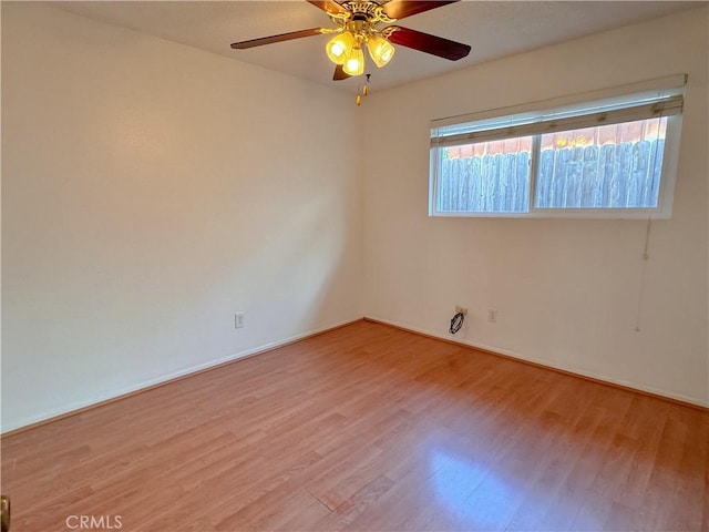 spare room with ceiling fan and light wood-type flooring