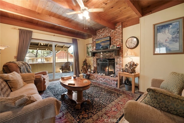 living room with beamed ceiling, a fireplace, wooden ceiling, and ceiling fan