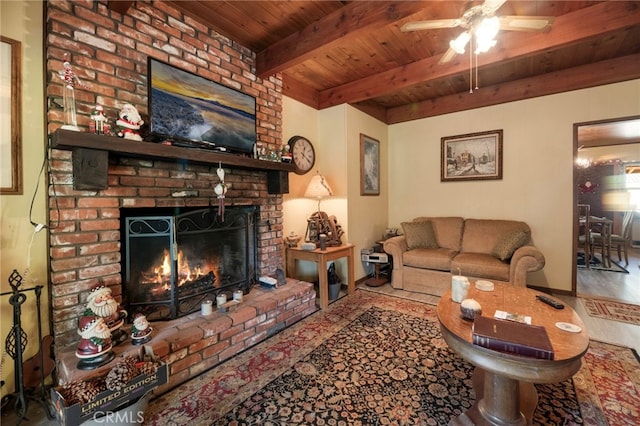 living room with a brick fireplace, hardwood / wood-style flooring, ceiling fan, beam ceiling, and wood ceiling