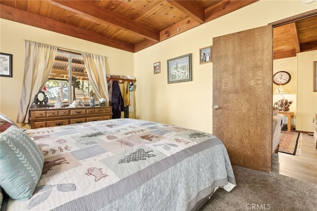 bedroom featuring beamed ceiling, hardwood / wood-style floors, and wood ceiling