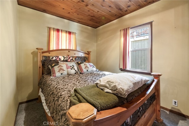 carpeted bedroom with wooden ceiling