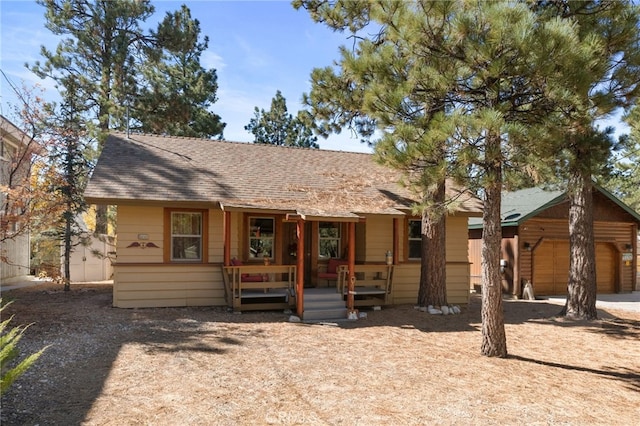 view of front of property with covered porch and a garage