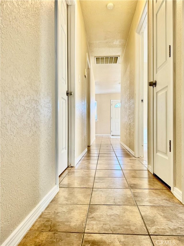 hallway with a textured ceiling