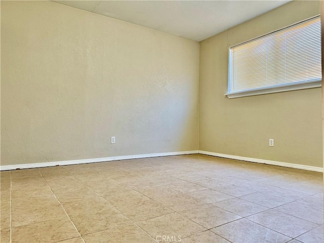 empty room with light tile patterned floors