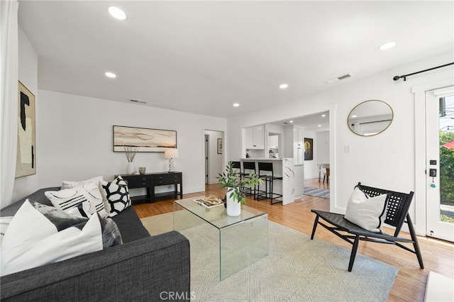 living room with light hardwood / wood-style flooring