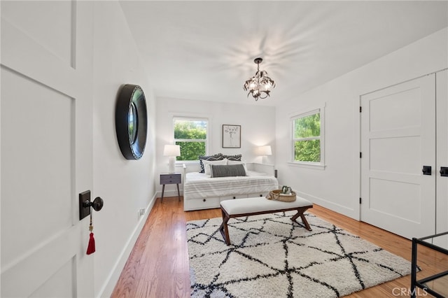 living room featuring wood-type flooring and a notable chandelier