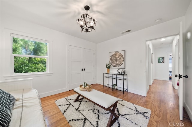 living room with wood-type flooring and a chandelier