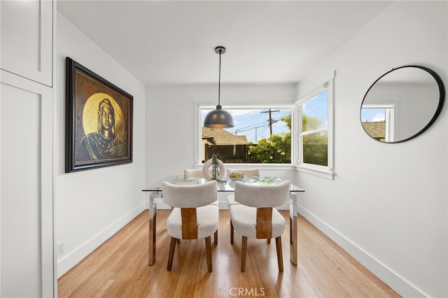 dining space with light hardwood / wood-style floors