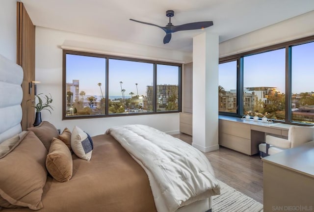 bedroom with ceiling fan and light wood-type flooring