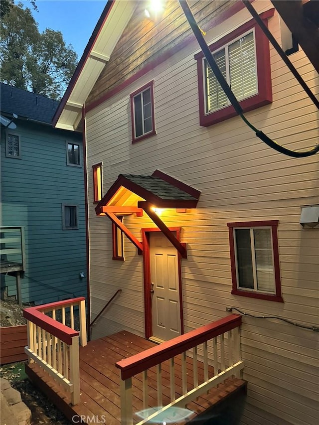 back of property featuring a wooden deck