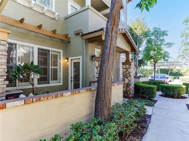 doorway to property featuring a pergola