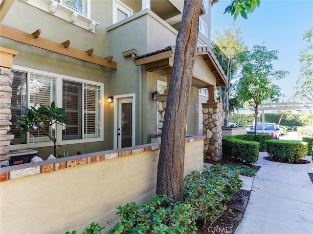 entrance to property with a pergola