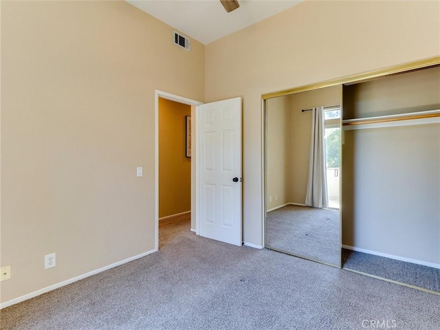 unfurnished bedroom featuring carpet flooring, ceiling fan, and a closet