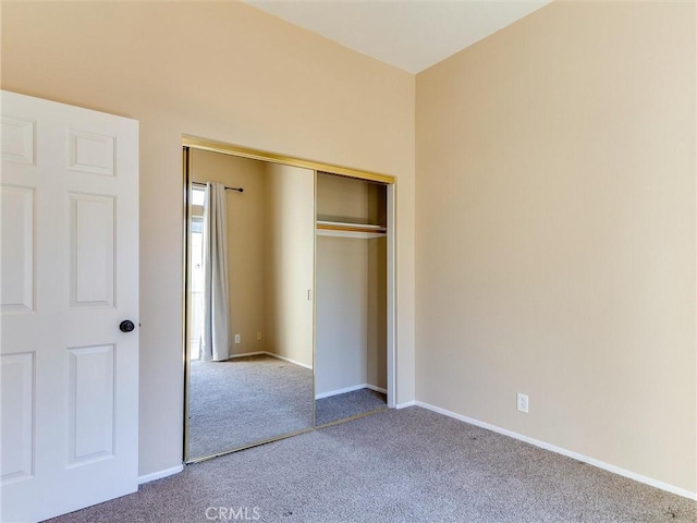 unfurnished bedroom featuring a closet and carpet flooring