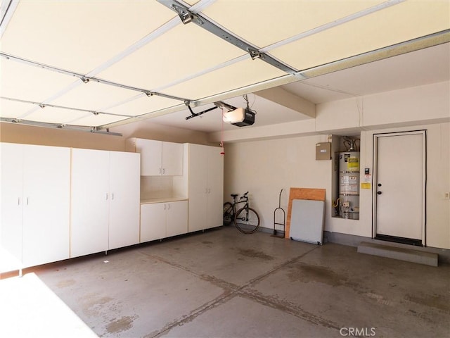 garage featuring a garage door opener and water heater