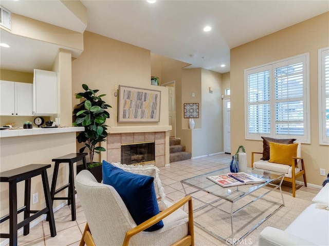 tiled living room featuring a tile fireplace