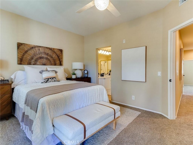 bedroom with ceiling fan, ensuite bath, and carpet