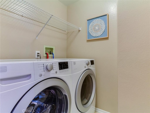 laundry room with washing machine and clothes dryer