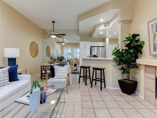 tiled living room featuring ceiling fan