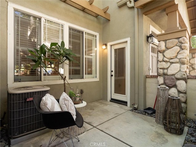 entrance to property with central AC and a patio