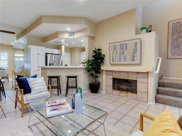 tiled living room featuring a tile fireplace