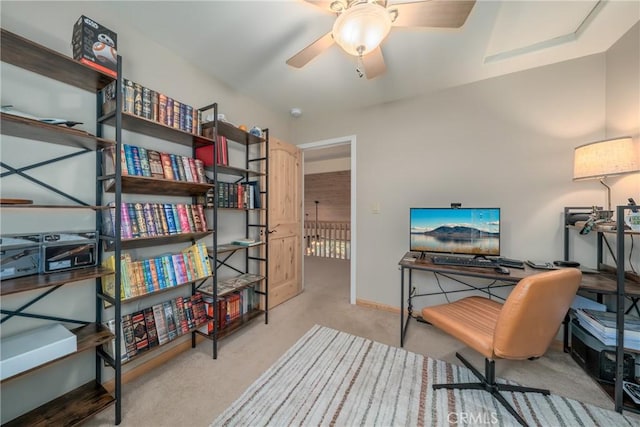 office area featuring light carpet and ceiling fan