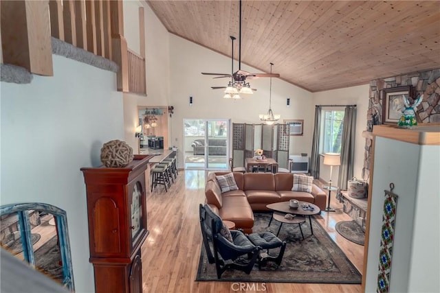 living room featuring ceiling fan with notable chandelier, light wood-type flooring, high vaulted ceiling, and wooden ceiling