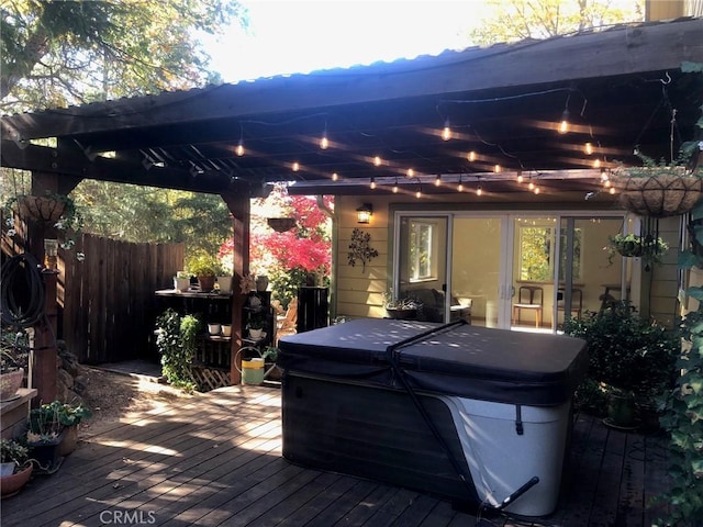 deck with a pergola and a hot tub