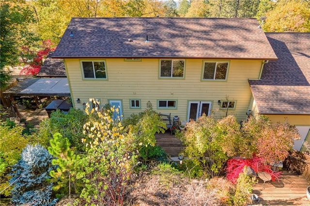 back of property featuring a wooden deck