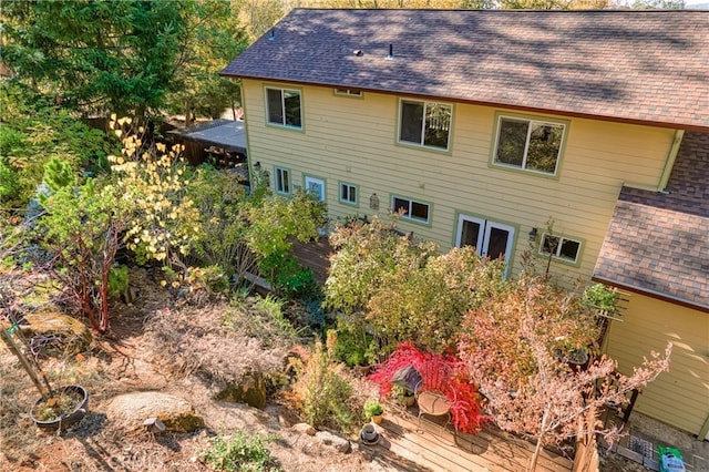 rear view of house featuring a wooden deck