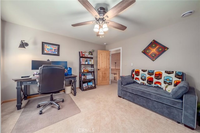 office space featuring ceiling fan and light carpet