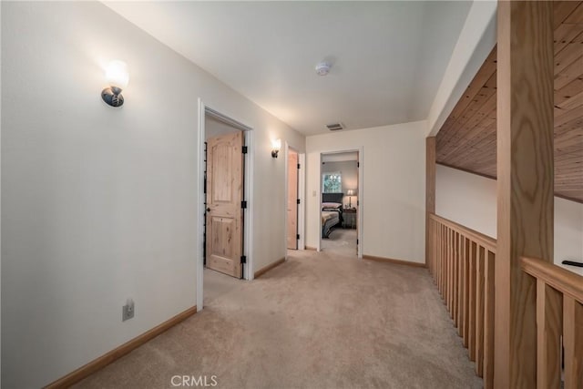 corridor featuring light colored carpet