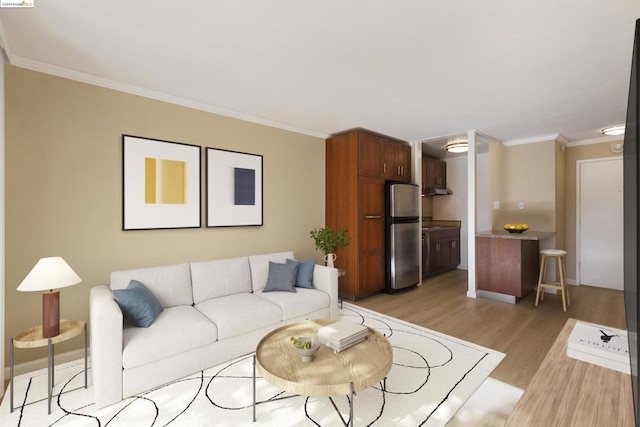 living room featuring light hardwood / wood-style floors and crown molding