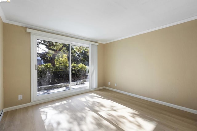 unfurnished room featuring baseboard heating, light hardwood / wood-style flooring, and ornamental molding