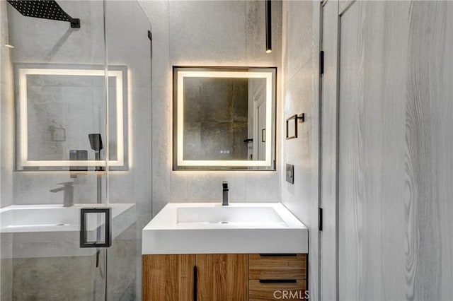 bathroom featuring vanity, a shower with door, french doors, and tile walls