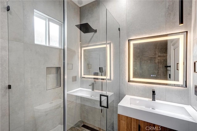 bathroom featuring vanity and a shower with shower door